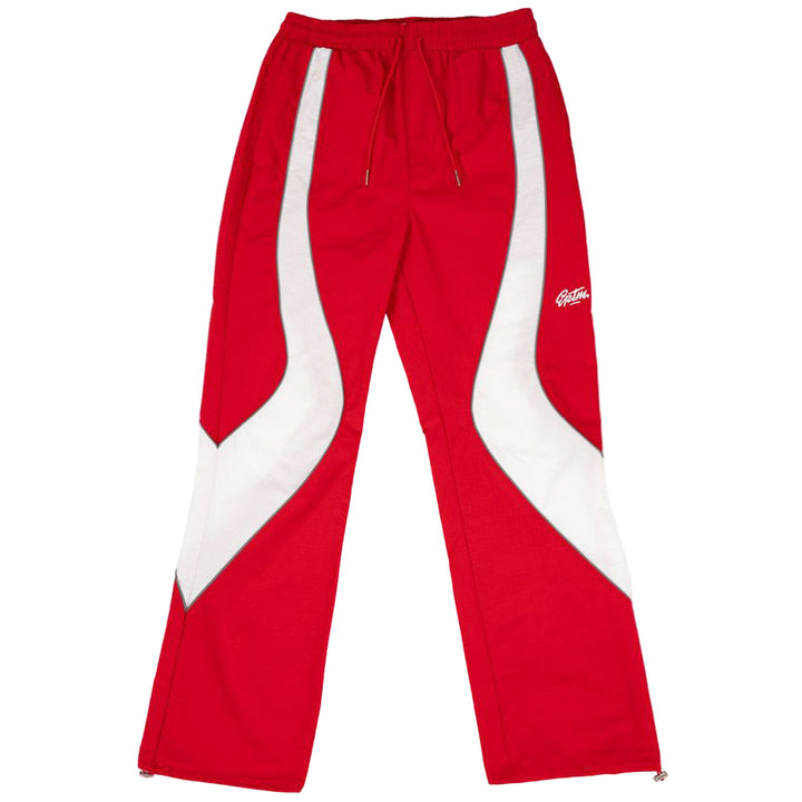 Red track pants with white stripes on a white background